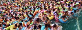 In this Sunday, Aug. 19, 2012 photo, people cool down in a swimming pool in Daying county, in southwestern China's Sichuan province. (AP Photo)  CHINA OUT